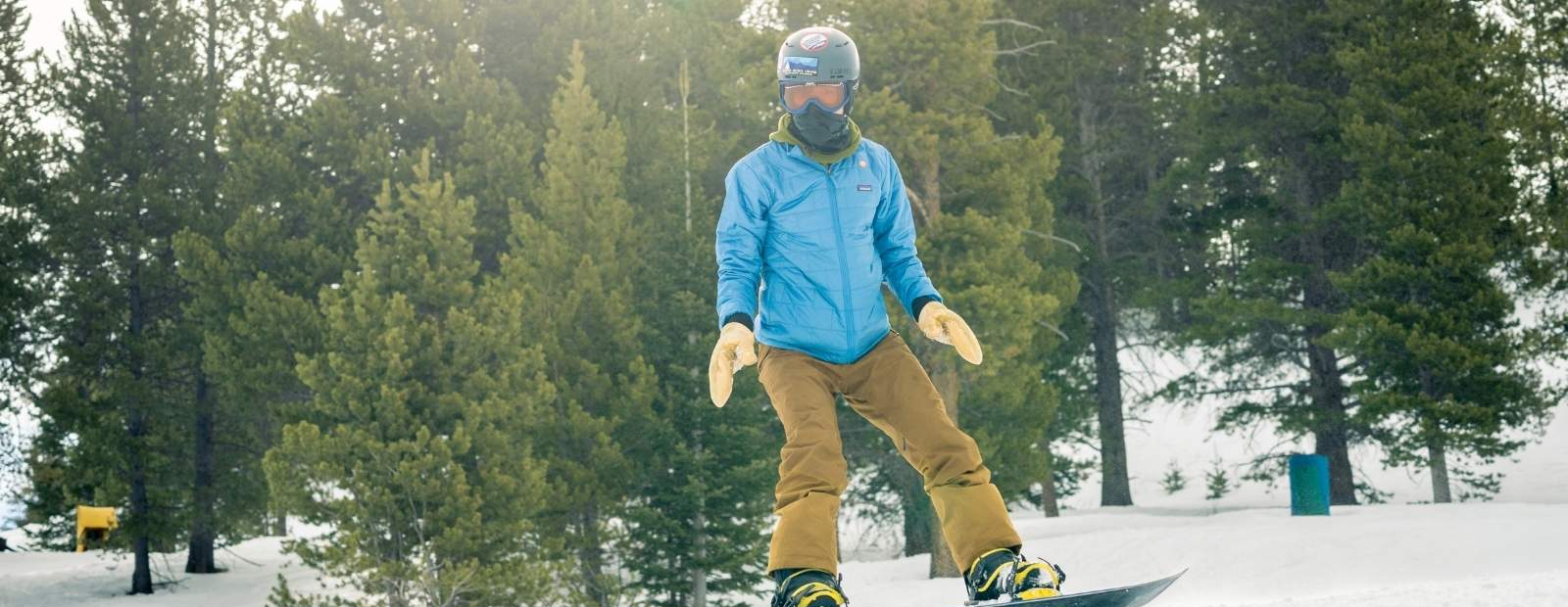 A boy snowboarding down the mountain