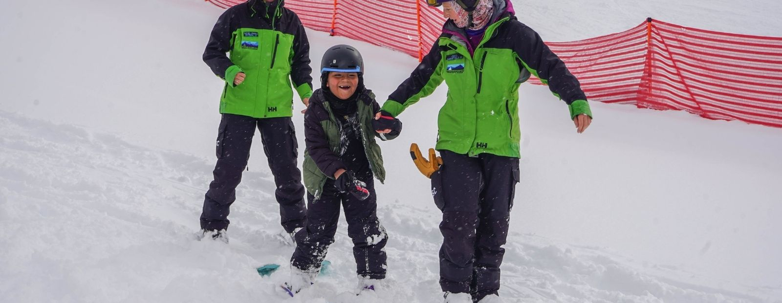 A child laughing while learning how to ski