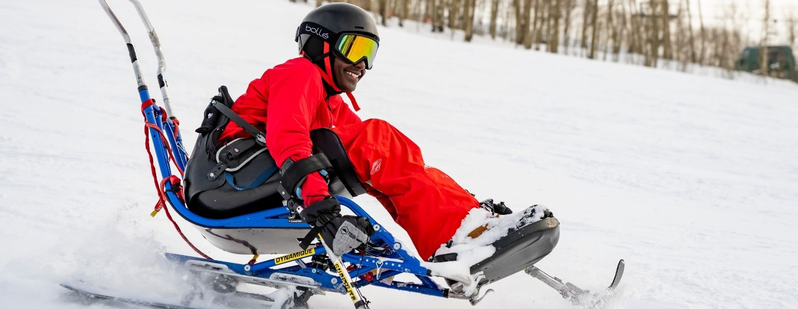 Photo of a man skiing down mountain on a bi-ski